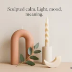 A styled candle vignette in clay pink and oat white with eucalyptus.