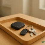 Wooden entryway tray with RFID tracker beside house keys, symbolizing calm and organization.